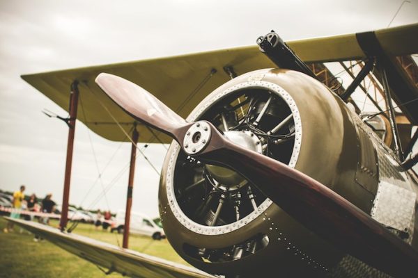 Vintage Green Propeller Plane Sitting on an Airfield - Example Image Alt Text